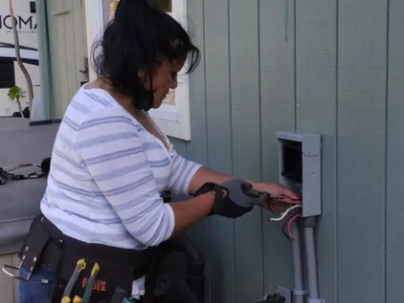 Licensed electrician wiring an exterior subpanel in Aptos
